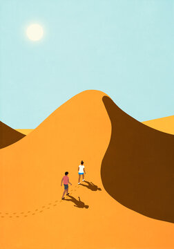 Couple hiking up steep, sunny sand dune in desert

