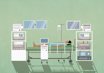 Male patient laying on operating table among technology equipment in operating room
