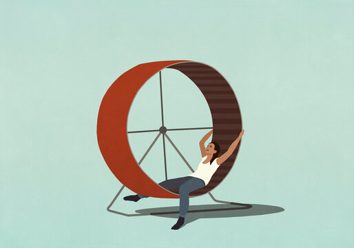Tired woman laying inside hamster wheel
