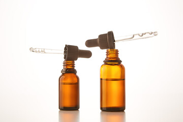 Two amber dropper vials with aromatherapy essence.