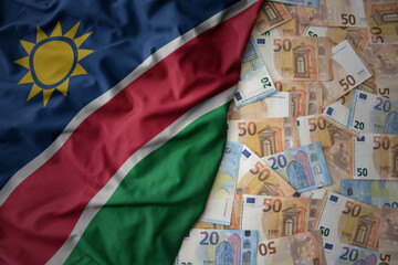 colorful waving national flag of namibia on a euro money background. finance concept
