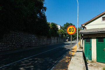 Yellow round 40 km speed limit sign on a road in Croatia on a sunny day