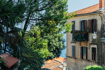 View of a multi-storey old house on the beach among coniferous trees