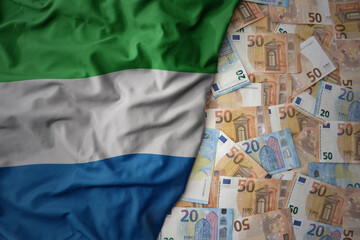 colorful waving national flag of sierra leone on a euro money background. finance concept
