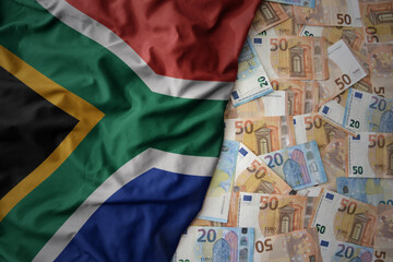 colorful waving national flag of south africa on a euro money background. finance concept