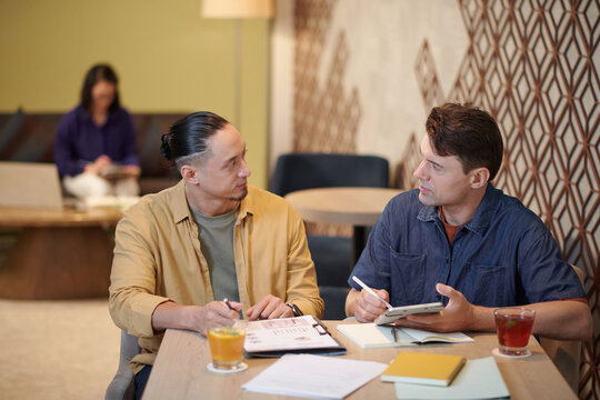 Startupper discussing potential sources of income with coworker