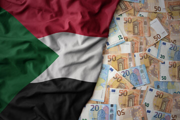 colorful waving national flag of sudan on a euro money background. finance concept
