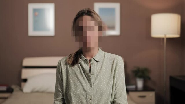 Hidden identity, hidden face, unknown person, silhouette interview. Woman talking to an interlocutor or looking at camera, her face is hidden