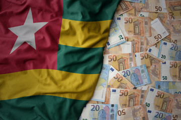 colorful waving national flag of togo on a euro money background. finance concept