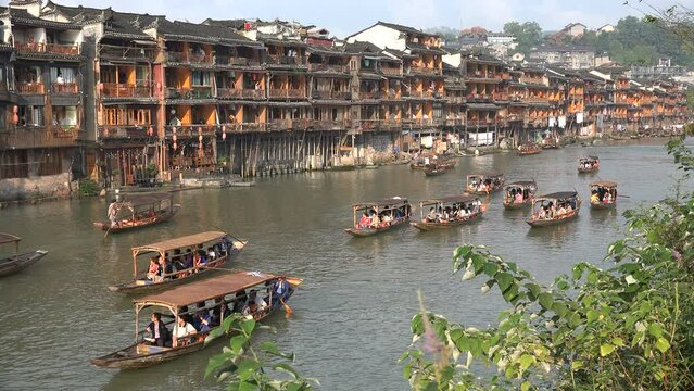 Chinese tourists sail through Fenghuang, a well preserved ancient town in central China. Many of the wooden buildings have been turned into guesthouses, hotels, and restaurants.
