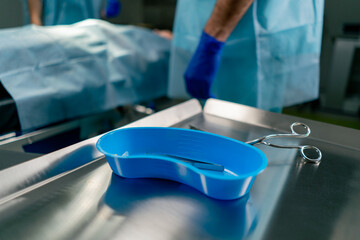 Close-up shot of sterilized scalpels and other metal instruments for surgery on table in an...
