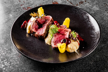 Slices of smoked beef steak served with mashed potatoes