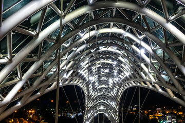 Fragment of pedestrian bridge over Kura River - Bridge of Peace at night. TBILISI, GEORGIA. © dbrnjhrj