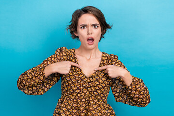 Photo of unsatisfied impressed girl point fingers self herself unexpected reaction isolated on blue color background