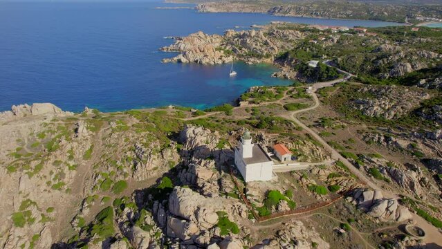 Panoramic aerial view over the lighthouse and the coast of Cape Testa on the island of Sardinia on a sunny day with beautiful colors.