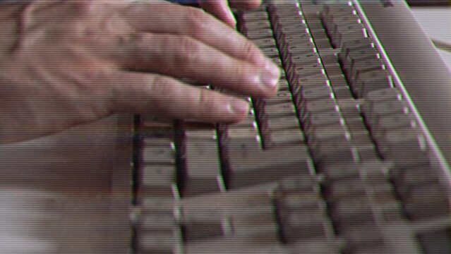 Computer engineer developer is working on old vintage computer 1990s. Antique classic pc keyboard and programmer typing hands. Internet web digital startup history. Outdated retro technology concept