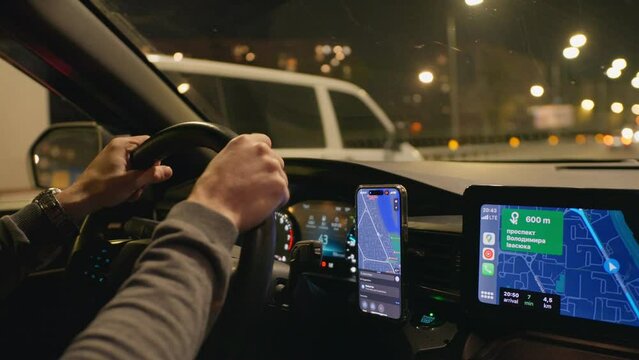 Drive night taxi street road man hand smartphone car town city