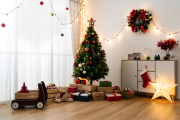 cozy comfortable children&rsquo;s play room interior with led light decors and Christmas tree with wrapped presents underneath