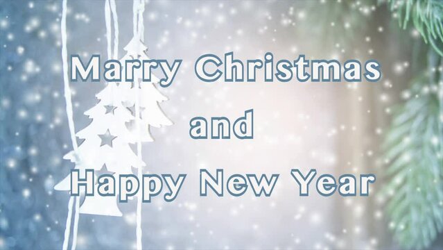 Merry Christmas and Happy New Year words design. Small wooden white Christmas trees on string on background of white-blue surface and green Christmas tree branch. Falling snow snowflakes snowfall