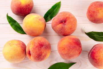 Fresh peaches on a wooden table.