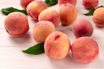 Fresh peaches on a wooden table. Summer peach fruit background.