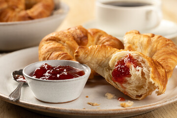 Croissants with strawberry preserves and cup of coffee - 675315997