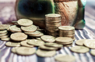 still life with ukrainian coins money hryvnia and ceramic piggy bank