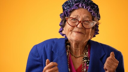 Closeup of funny happy smiling crazy grandmother mature woman, 80s, 90s, isolated on yellow background in studio - obrazy, fototapety, plakaty
