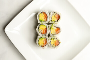 sushi roll with avocado, cucumber and salmon