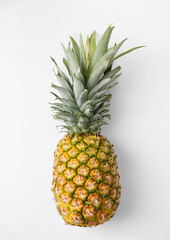 Fresh whole pineapple with green leaves on white background