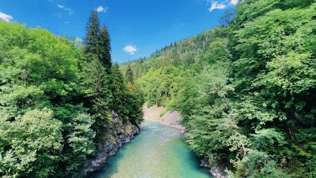 The Bolshaya Laba River. A mountain emerald river in a narrow, sunlit canyon. Bolshaya Laba River near the village of Psemen in Karachay-Cherkessia, Russia. Panoramic view. 4K