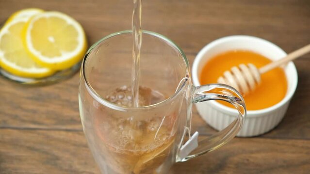 Preparation of packaged black tea, boiling water is poured into a cup with a tea bag.