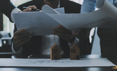 Construction and structure concept of Engineer or architect meeting for project working with partner and engineering tools on model building and blueprint in working site, contract for both companies.