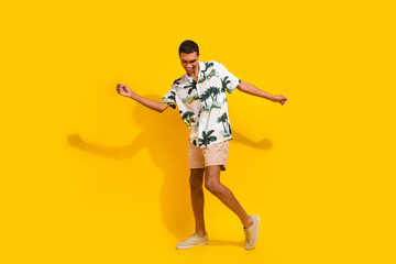 Full length photo of nice young male dancer cool have fun dressed stylish palms print garment isolated on yellow color background