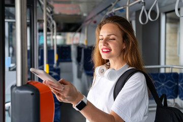 Young urban woman pays for a bus ticket using her mobile phone. Contactless mobile payment...