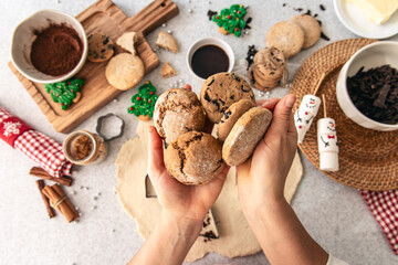 Homemade cookies in female hands, Christmas baking, top view.