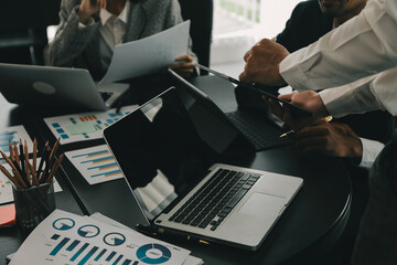 Close up of Business team analyzing income charts and graphs with modern laptop computer. Business analysis and strategy concept.