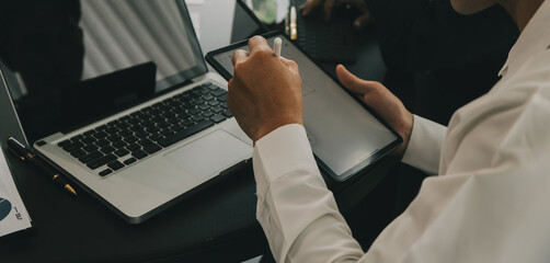 Close up of Business team analyzing income charts and graphs with modern laptop computer. Business analysis and strategy concept.
