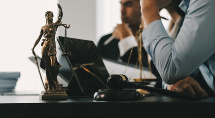 Business and lawyers discussing contract papers with brass scale on desk in office. Law, legal services, advice, justice and law concept picture with film grain effect