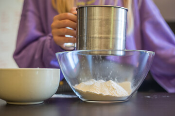 Kid's Hands Sifting Flour Up Close