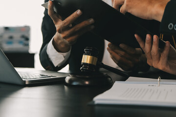 Consultation and conference of Male lawyers and professional businesswoman working and discussion having at law firm in office. Concepts of law, Judge gavel with scales of justice.