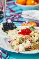 Close-up of plate with portioned Olivier salad on the New Year's table. Party in Russian style