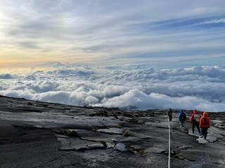 Group of hikers making their way up a rocky mountain path on Mount Kinabalu, Sabah, Malaysia