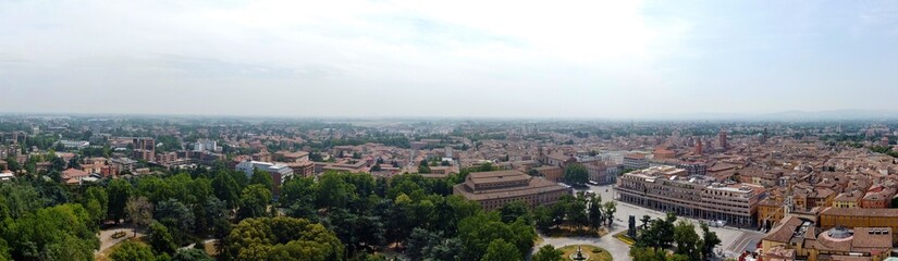 Fototapeta na wymiar Aerial view of Reggio Emilia, Emilia Romagna, Italy. In the foreground, the city park also called the People's Park with Victory Square and the two theaters
