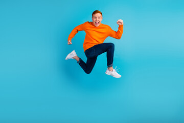 Fototapeta na wymiar Full length photo of crazy funky man run empty space isolated blue color background