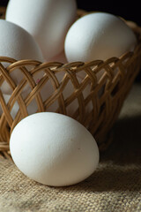 White eggs in a wicker basket