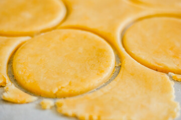 pastry-making with this captivating image featuring a close-up of perfectly cut shortcrust dough circles in a kitchen setting