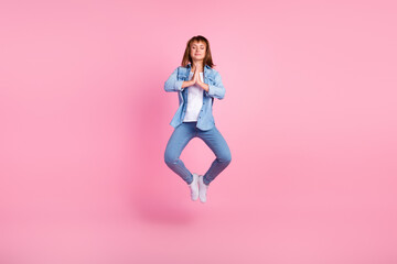 Fototapeta na wymiar Full body photo of young girl jumping dressed stylish outfit isolated on pink color background