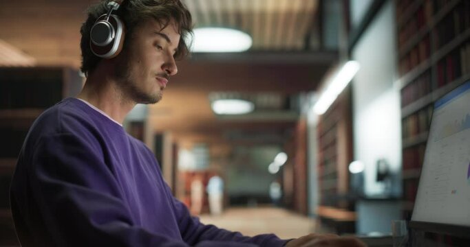Thoughtful European College Student Using Desktop Computer to Study in a Public Library. Handsome Man Learning Online, Reading a Marketing Presentation and Getting Ready for Exams. Close Up Portrait