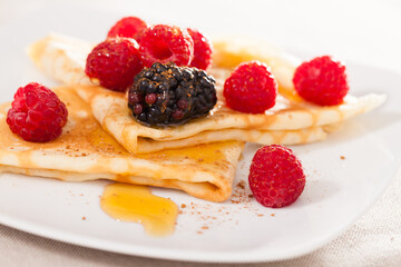 Pancakes with raspberries, blackberries and honey